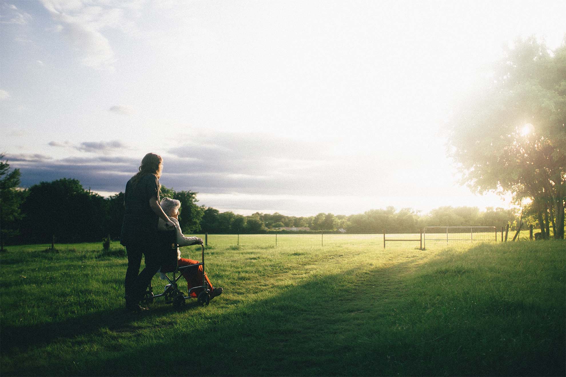 resident and carer on a walk together