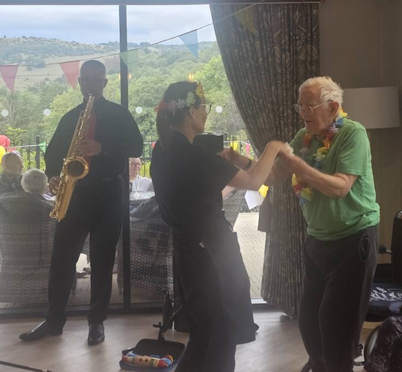 resident dancing with a carer