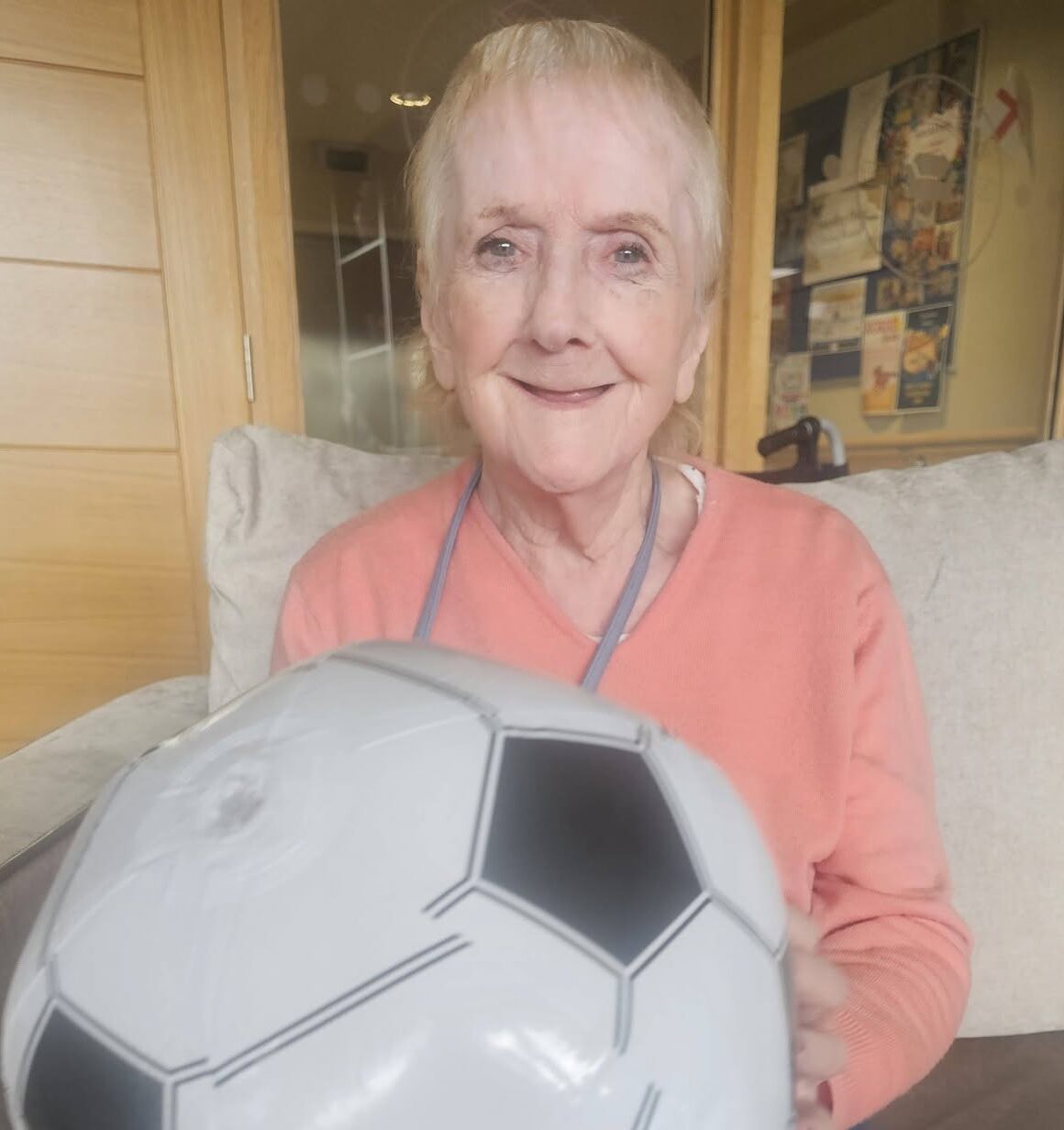 older lady holding an inflatable ball