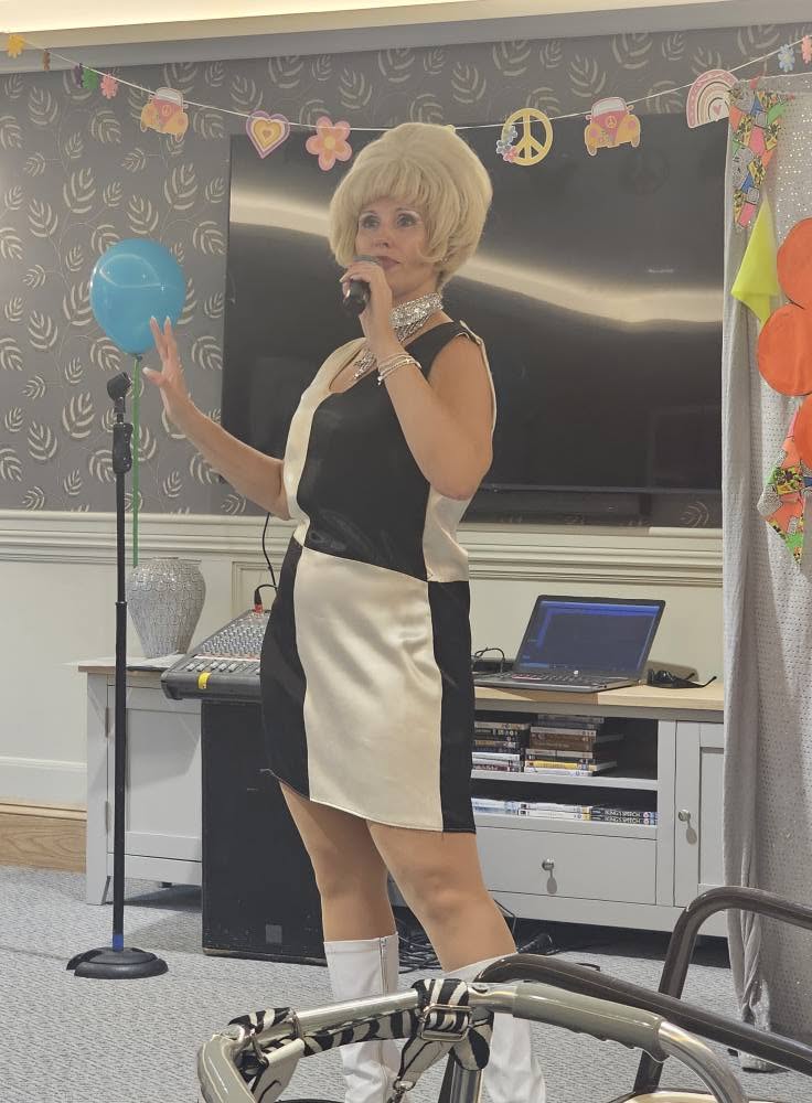 lady in a dress with blonde hair singing