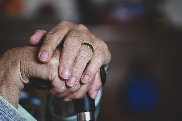 older adult holding walking stick