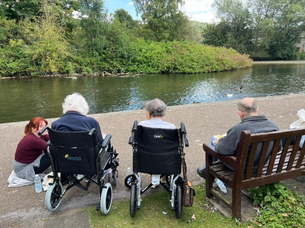 residents sat by the pond chatting