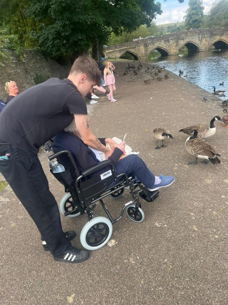 resident eating fish and chips by the ducks