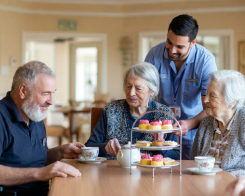 residents enjoying afternoon tea and chatting with carer