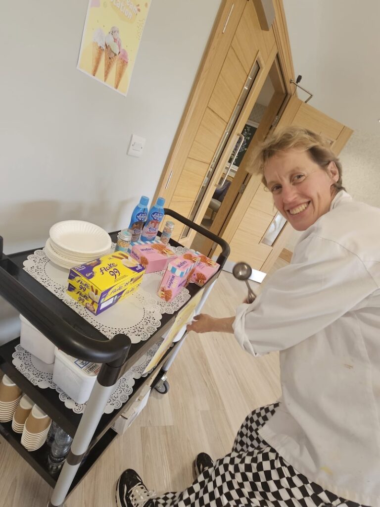 one of our team taking a sweet treat round to residents